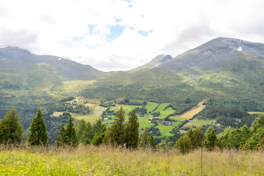 Beautiful green landscape of a hiking trail above the village. A seasonal scenery of Eidsdal village in World Heritage area of Western Norway.
