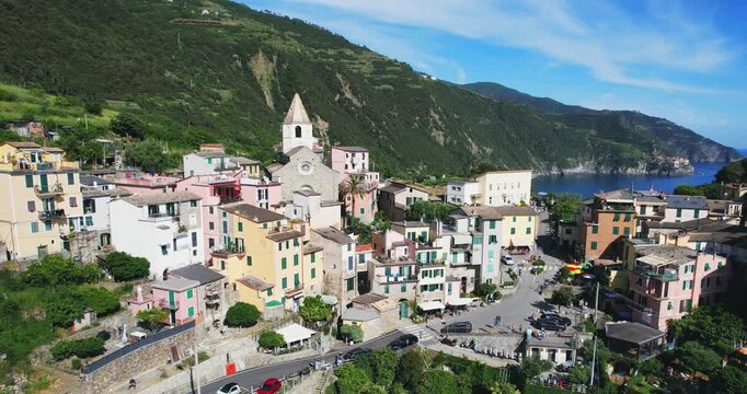 Breathtaking aerial photo showcasing the colorful homes and historic church of Corniglia in Cinque Terre, Italy