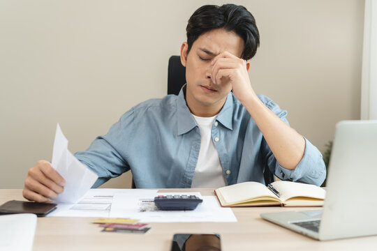 Stressed bankrupt financial crisis concept, Young adult in nervous after calculated loan expense and can not pay to bank.