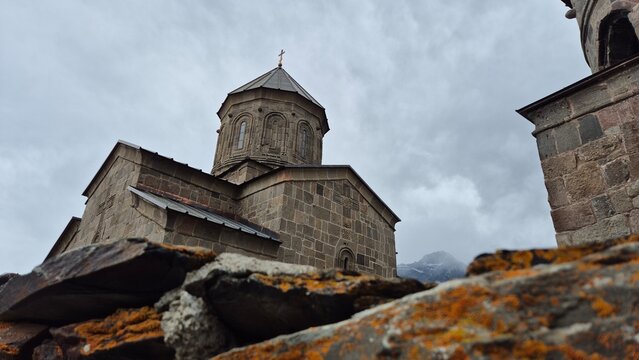 Low Angle View of Ancient Gergeti Trinity Church Against Overcast Sky in Stepantsminda, Georgia