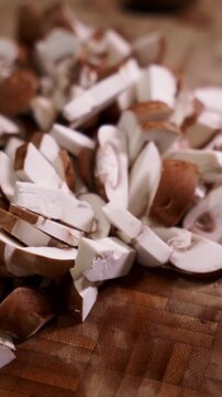 Freshly sliced portobello mushrooms on wooden cutting board, macro shot.