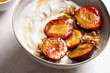 Roasted plums with yogurt, honey and nuts