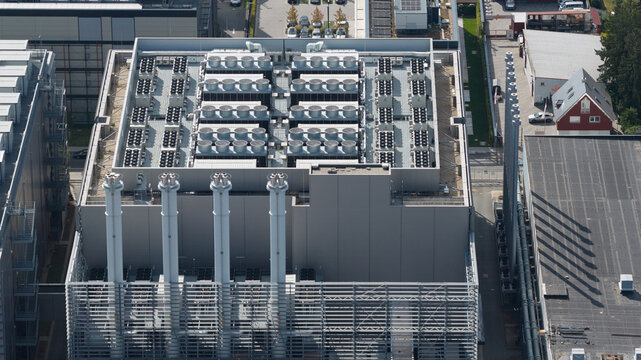 Aerial view of an industrial facility featuring a roof with numerous ventilation units and four tall chimneys in Frankfurt am Main, Hessen, Germany.
