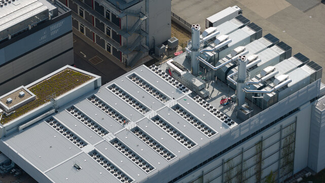 Aerial view of a data center roof featuring numerous HVAC ventilation units and a green roof section in Frankfurt am Main, Hessen, Germany.