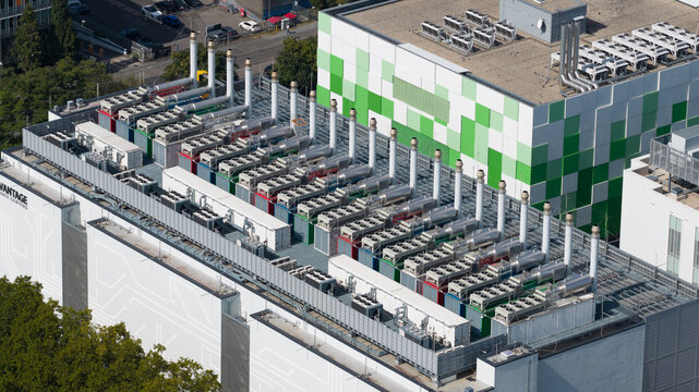 Aerial view of the industrial cooling units and HVAC infrastructure on the roof of a modern data center in Frankfurt am Main, Hessen, Germany.