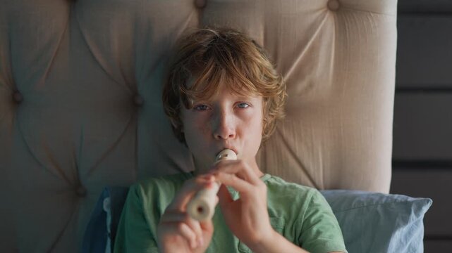 A little boy learns to play the flute at home, practicing with focus and enthusiasm in a cozy, warm setting. A charming scene of early musical exploration, creativity, and childhood growth.