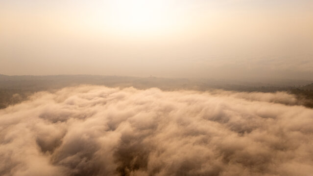 Aerial view of a sea of clouds covering the mountainous landscape near Selo, Central Java, Indonesia.