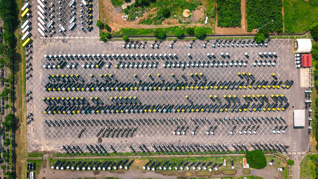 Aerial view of a truck factory with rows of parked commercial vehicles in India.