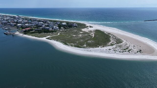 Scenic beach and coastline at Wrightsville Beach, NC with natural inlet waterway and sand dunes in summer