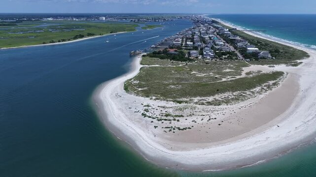 Scenic beach and coastline at Wrightsville Beach, NC with natural inlet waterway and sand dunes in summer