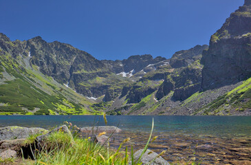 Beautiful view of Czarny Staw Gasienicowy glacial lake in High Tatra Mountains, scenic mountain landscape with crystal clear water and copy space. © Mateusz