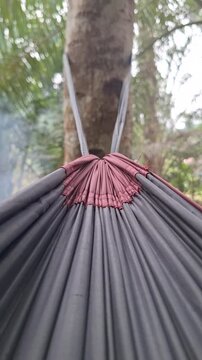 Close-up of gathered gathered end hammock gathered channel suspension system outdoors for camping, relaxation, and travel concept
