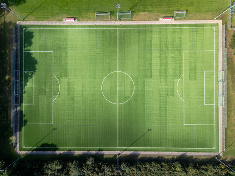 Aerial view of a football pitch with green artificial turf and white markings in Rellingen, Schleswig-Holstein, Germany.