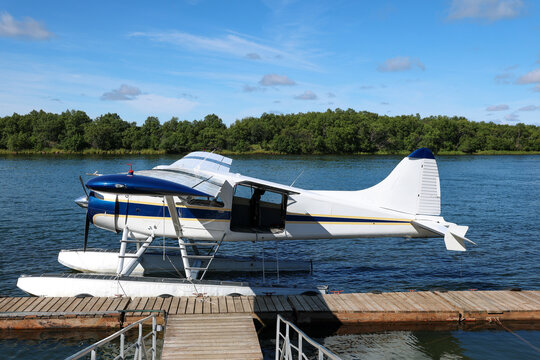 Small float plane designed to fly in remote Alaska bush takes off and lands on Alaskan river water for adventure.