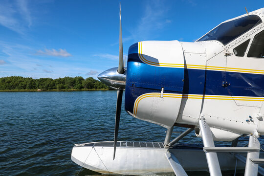 Small float plane designed to fly in remote Alaska bush takes off and lands on Alaskan river water for adventure.