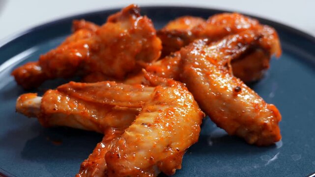 Baking chicken wings in the oven at home. 
Festive tasty dinner. Beautiful kitchen video. 
Appetizing meat dish.