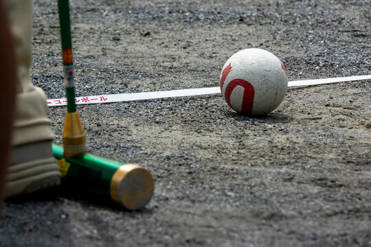Close-up of a gateball mallet and ball on a gravel court, Kanto region, Tokyo, Japan