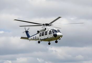 Fototapeta premium Emergency medical services and search and rescue helicopter, modern aircraft in flight for rapid response and disaster relief operations in cloudy sky