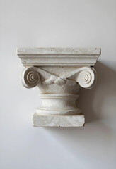 Obraz premium Architecture and history concept, classical ionic column capital made of beige marble stone isolated on a clean neutral background for interior design