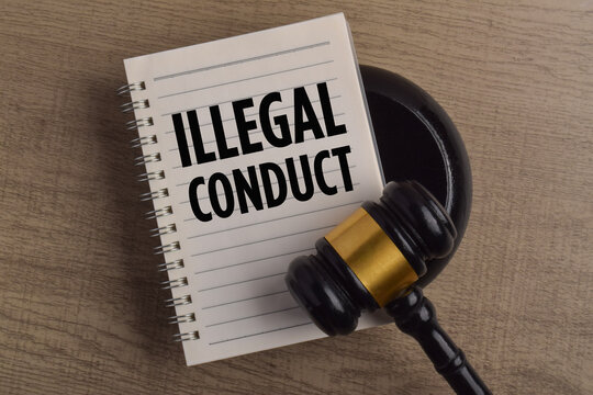 Gavel and notebook displaying illegal conduct, representing law, legal violations, crime, justice, regulation, and judicial proceedings.