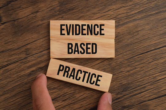 Wooden blocks labeled evidence based practice, representing research, data, scientific knowledge, clinical decisions, analysis, and informed professional approaches.