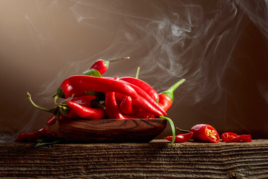 Red hot chili peppers on an old wooden table.
