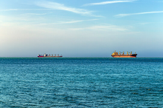 Rendezvous of two ships on the high seas. Strait of Hormuz. Tanker ship on the horizon