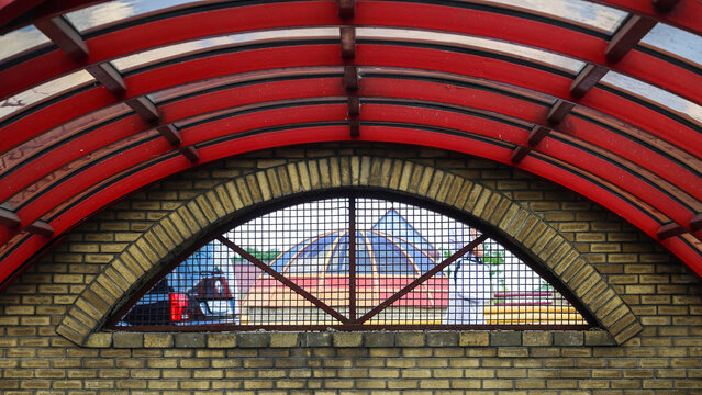 Staircase descent into underground pedestrian passage featuring a striking red spherical dome ceiling.