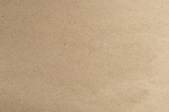 Recycled Natural Brown Kraft Paper Texture Background,Macro,A high-resolution top-down macro photograph of a natural brown kraft paper sheet texture showing fine organic fibers and subtle flecks.