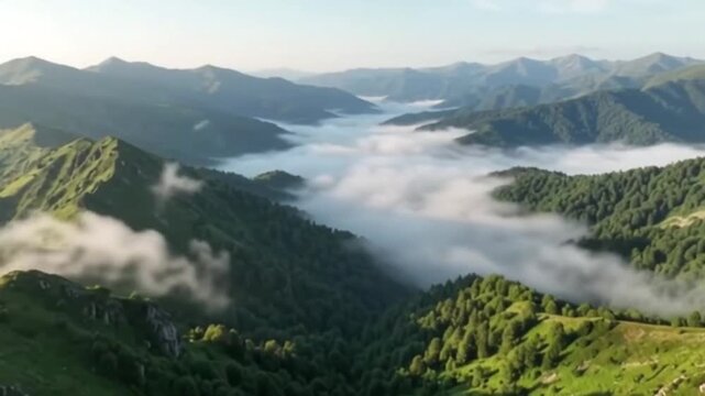 Majestic green mountain peaks covered by moving rolling valley clouds footage