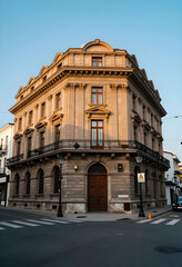Obraz premium Urban heritage and historic architecture, classic stone building with ornate facade and balcony on a city street corner during golden hour sunset