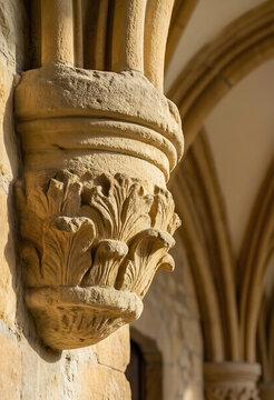Architectural heritage and historical preservation, ornate stone corbel with gothic leaf carving on a medieval cathedral wall in warm sunlight