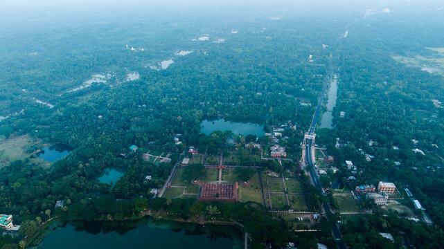 Aerial view of the historic Sixty Dome Mosque surrounded by lush greenery, ponds, and rural landscape in Bagerhat, Khulna Division, Bangladesh.
