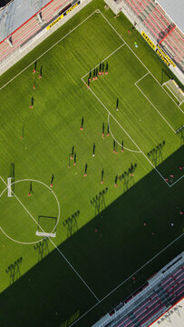 Aerial view of a soccer match in progress at the Stadion Shopping Center with players on the green pitch, marked lines, and stadium seating in Beograd, Grad Beograd, Serbia.