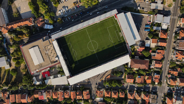 Aerial view of the Stadion Shopping Center featuring the Vozdovac Stadium on its roof, surrounded by urban residential buildings and streets in Beograd, Grad Beograd, Serbia.