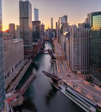 Elevated view of multiple raised bascule bridges spanning the Chicago River between downtown skyscrapers.
