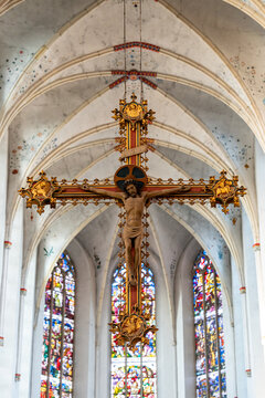 Medieval crucifix hanging from the ceiling inside gothic church in Holland