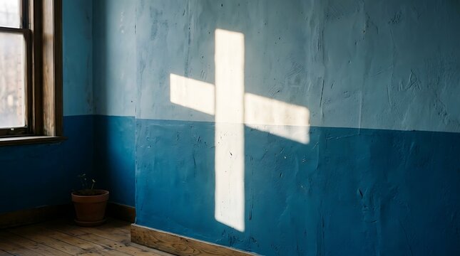 Sunlight forming a cross shape on a blue textured wall in a room