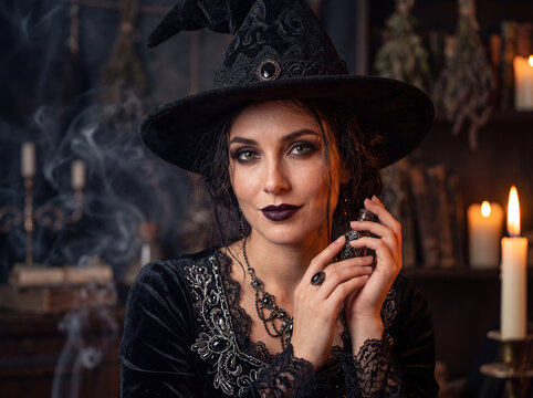 Mysterious woman in witch attire holds her hand