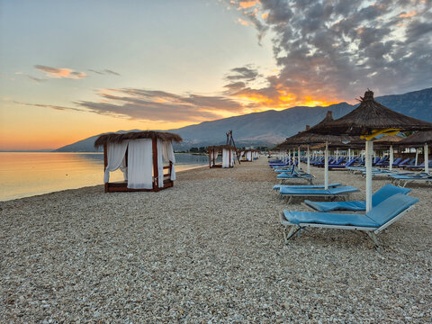 Serene sunset at Orikum beach in Vlor&euml;, Albania with cozy beach cabanas