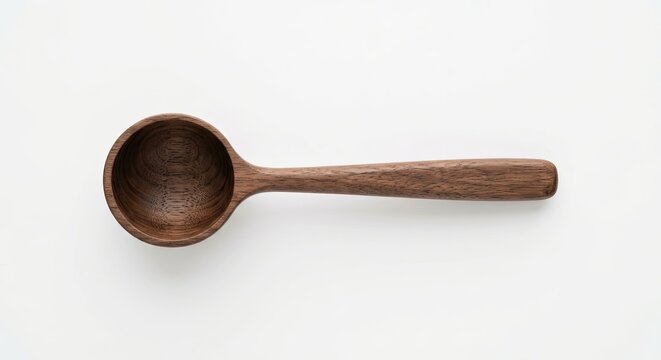 Dark wood measuring spoon on white background.