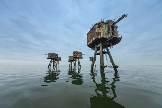 Kent, United Kingdom - 27 March 2019: View of the abandoned Red Sands Sea Forts standing on stilts in the Thames Estuary under a cloudy sky.