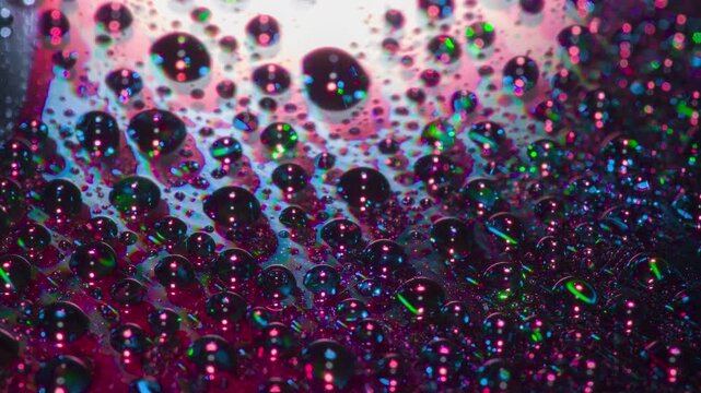 Laser Effect on the Drug. A mirror surface with drops of a chemical composition applied to it slowly rotates in laser beams of varying frequencies