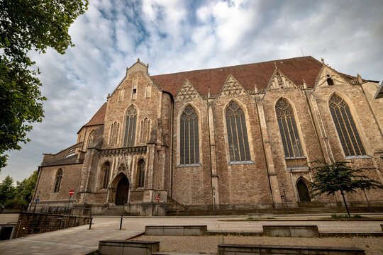 Braunschweig, Germany - July 3, 2026: Elaborate Gothic stonework, pointed windows and a central entrance decorate the exterior of St. Martini Church.