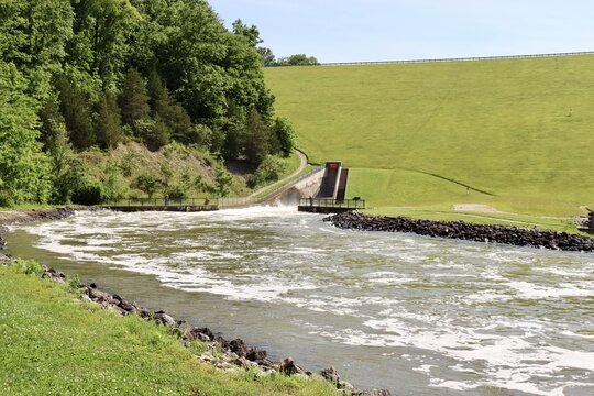 The open dam spilling in the creek in the park.
