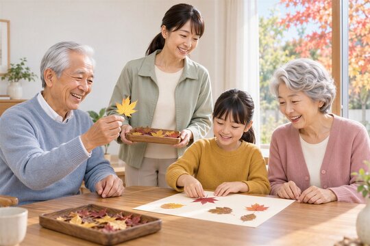 秋の落ち葉を使った工作を楽しむ日本人三世代家族