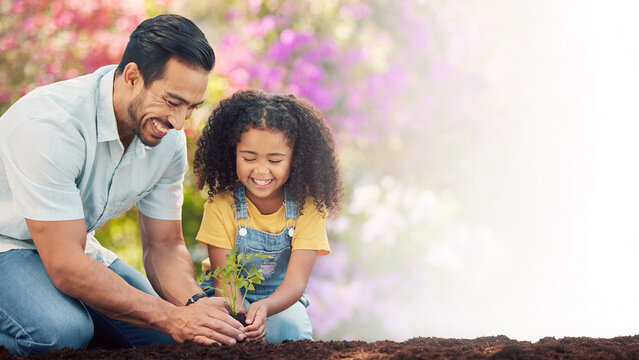 Smiling father and daughter planting green seedling with blurred blooming garden background banner.