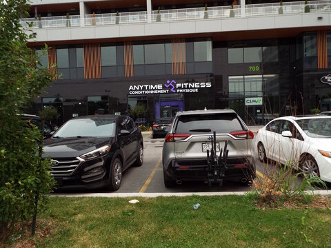Gatineau, Quebec, Canada &ndash; July 04, 2026: An outdoor view showing the storefront of "Anytime Fitness" at 700 Boulevard de la Gappe with parked cars.