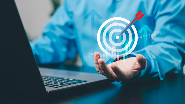 Financial growth concept, business success, investment strategy, financial goals, trading and economic growth. Target, upward arrow and market trend chart with a businessman using a laptop.
