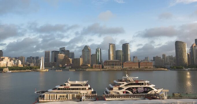 SHANGHAI, CHINA - AUGUST 23, 2026: Docked cruise boats sit at the pier as the North Bund skyline transitions from night to day along the Huangpu River in SHANGHAI, China, in timelapse